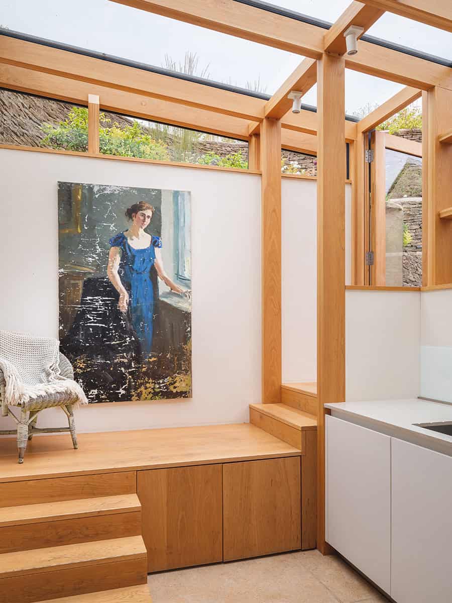 The Mount glazed oak extension interior with built-in bench, artwork and roof light, Stroud